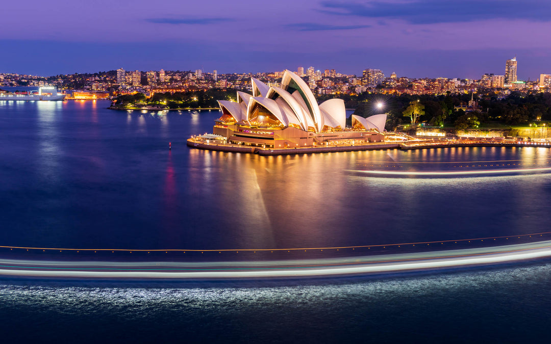 A ferry boat passes in front of the Sydney Opera House
